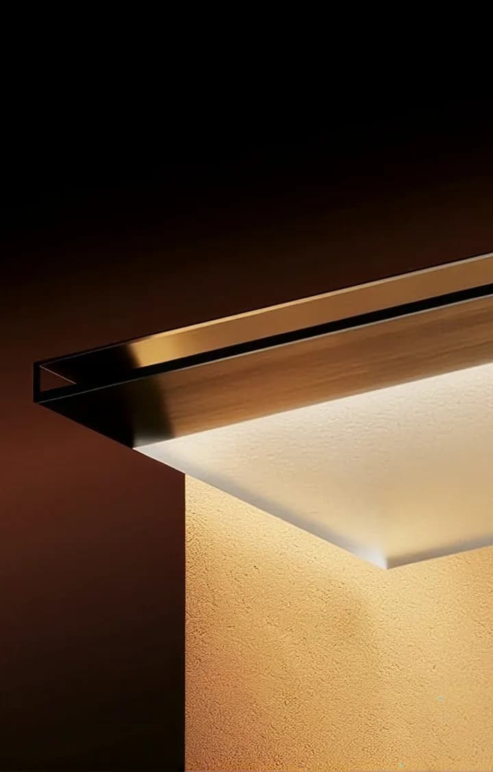 A backlit timber shelf casting warm light across a textured wall.